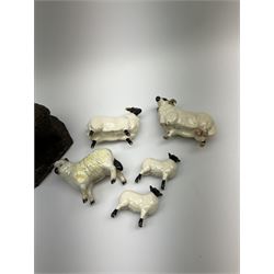 Two Beswick rams, two lambs, and a further sheep, together with a bronzed model of two sheep. 