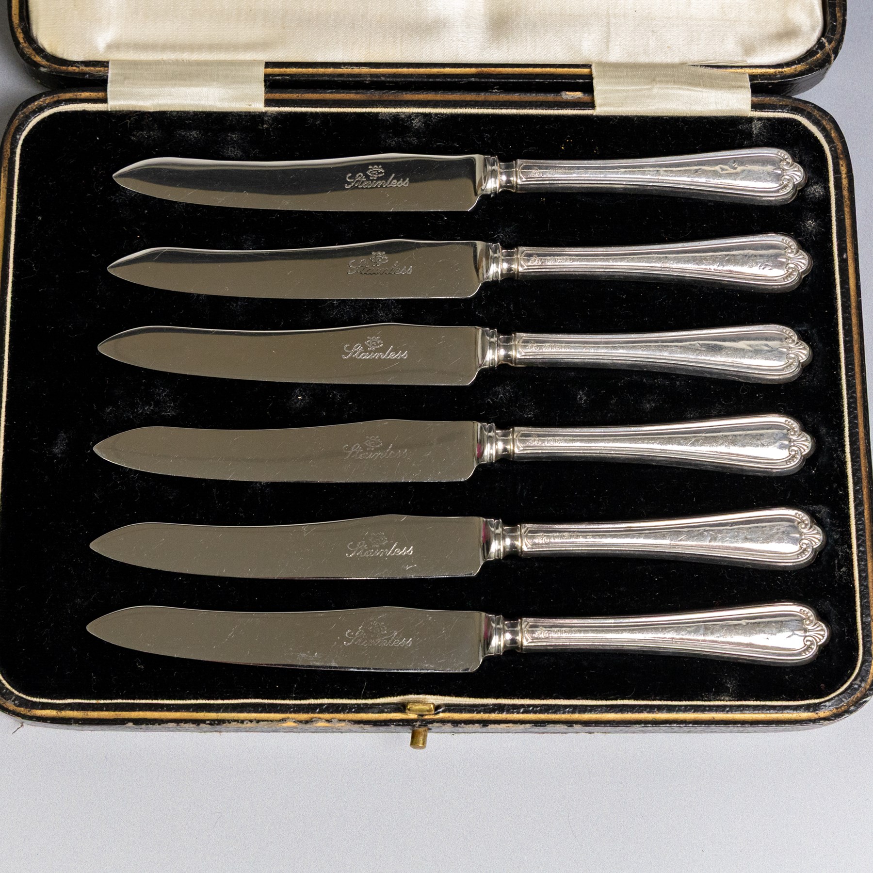 Set of six 1920s silver teaspoons with engraved initials, together with two sets of silver handled tea and fruit knives, all hallmarked and all within fitted cases