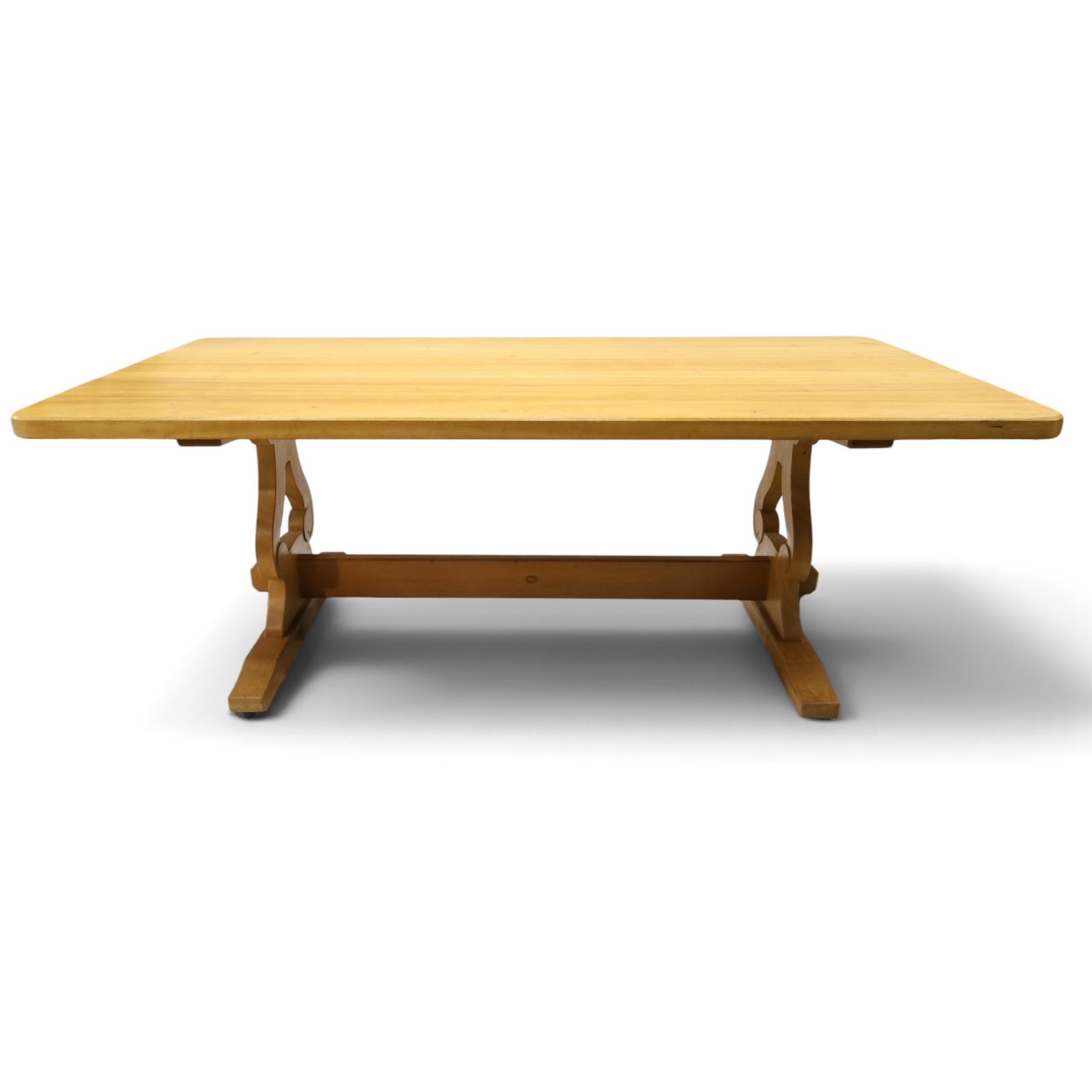 Acorn Industries - oak dining table, rectangular top with rounded corners and chamfered edge, raised on twin lyre-shaped supports united by pegged stretched on sledge feet, carved with acorn signature to stretcher, by Alan Grainger, Brandsby