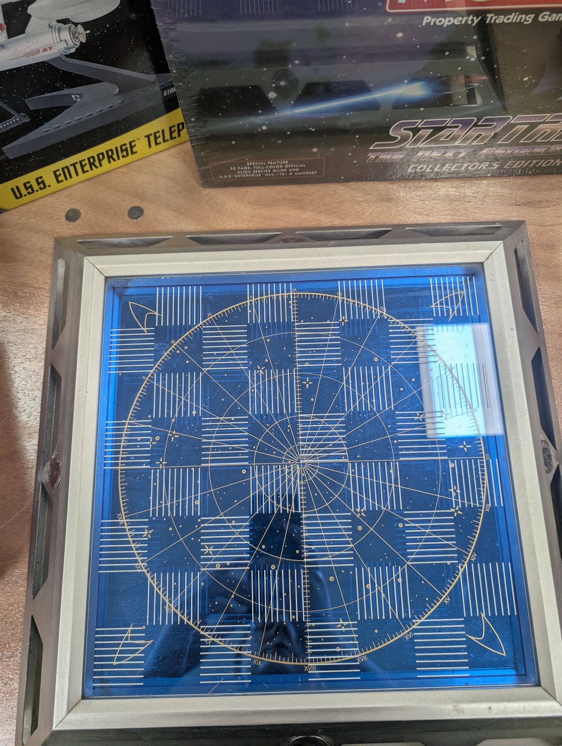 Star Trek Paramount Pictures Official Chess Set, incluidng glass board with removable lid, opening to reveal full set of gold and silver plated pewter figural chess pieces, with certificates, together with a Star Trek USS Enterprise Telephone, Star Trek Monopoly, 30th Anniversary DVD box set, Star Trek novels, DVDs, CDs, etc