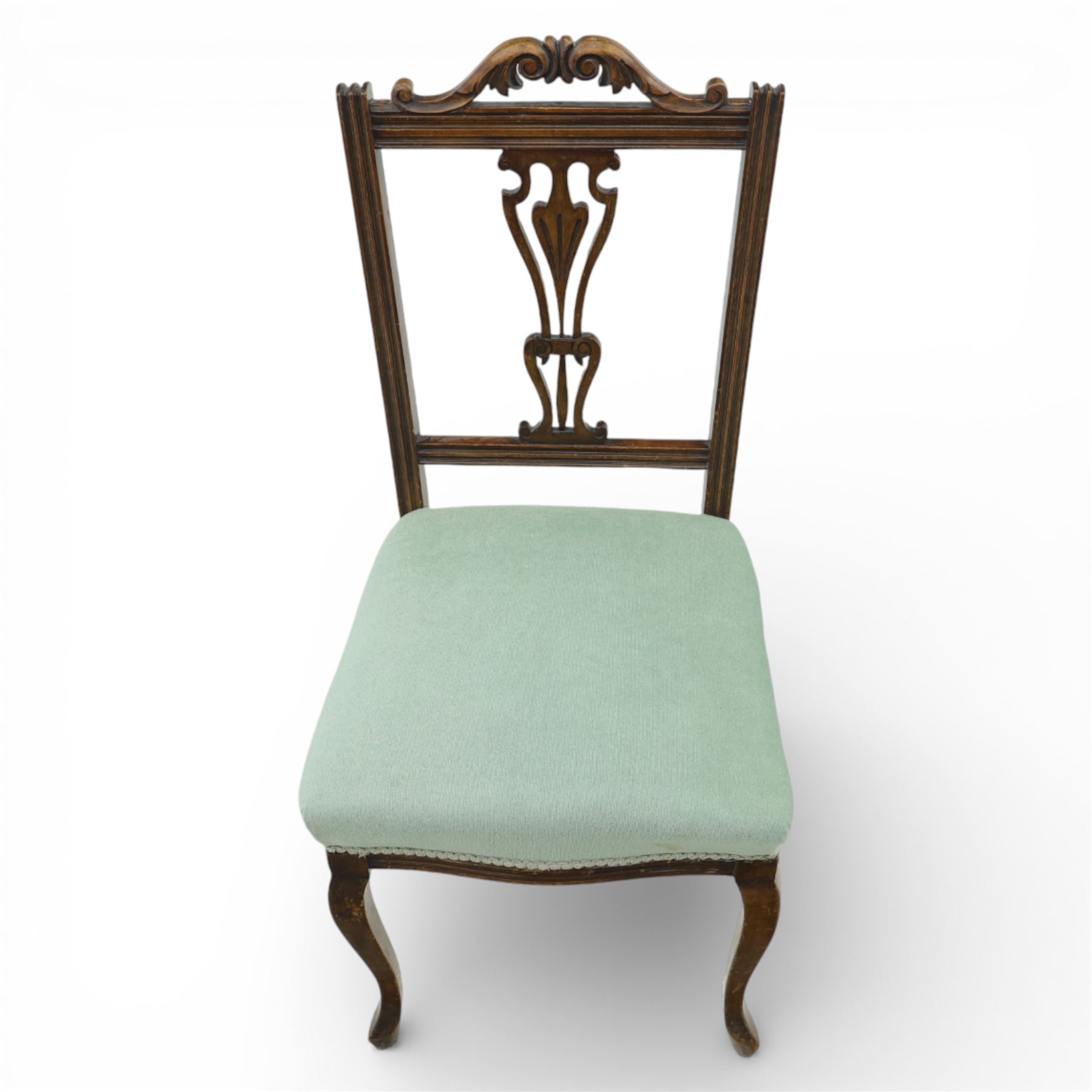 Late Victorian mahogany side chair, the carved cresting rail above a pierced and carved splat with lyre-form detail, the back panel inset with cane work, drop-in upholstered seat in pale green fabric with braid trim, raised on cabriole supports