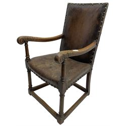 17th century design oak armchair, high back and seat upholstered in tan leather with studwork, scrolled arm terminals with carved acanthus detail, on turned supports united by box stretcher