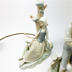 A group of figurines, to include a large Nao example, H32.5cm, and a Lladro table lamp, (a/f). 