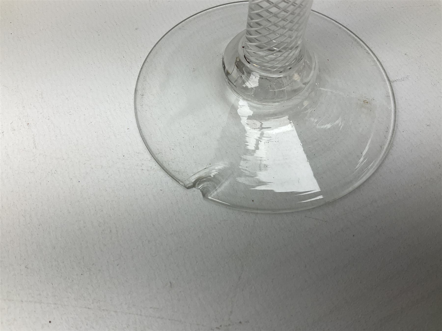 18th century drinking glass, the funnel bowl raised upon a single