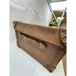 Early 20th century leather trunk, with brass fixtures, leather straps and buckle fastenings, embossed to the top with initials GG, H28cm, W76cm