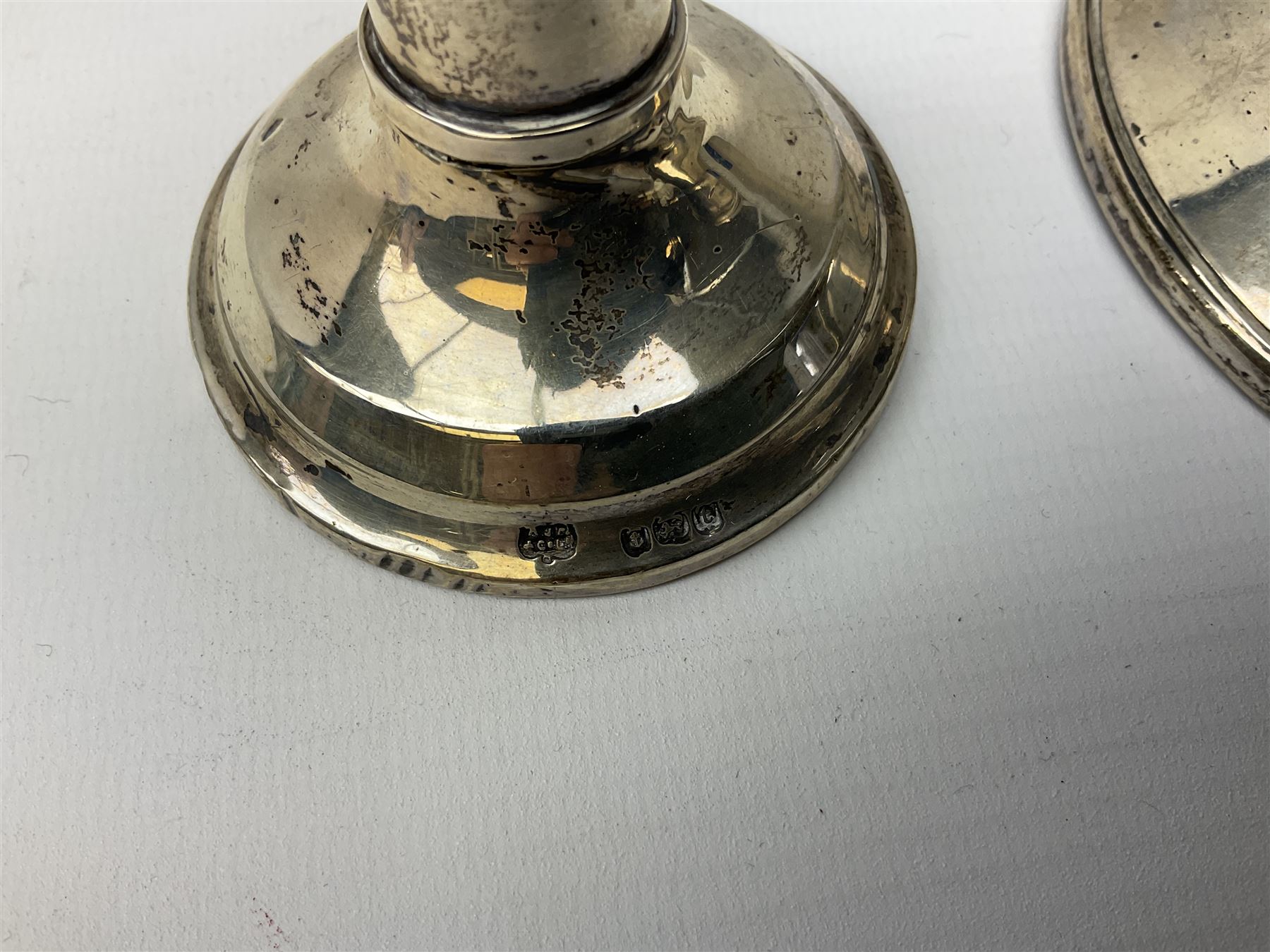 1920's silver mounted capstan inkwell, hallmarked Charles Boyton & Son Ltd, London 1929, together with an early 20th century silver mounted dwarf candlestick, hallmarked A J Pepper & Co, Birmingham 1918