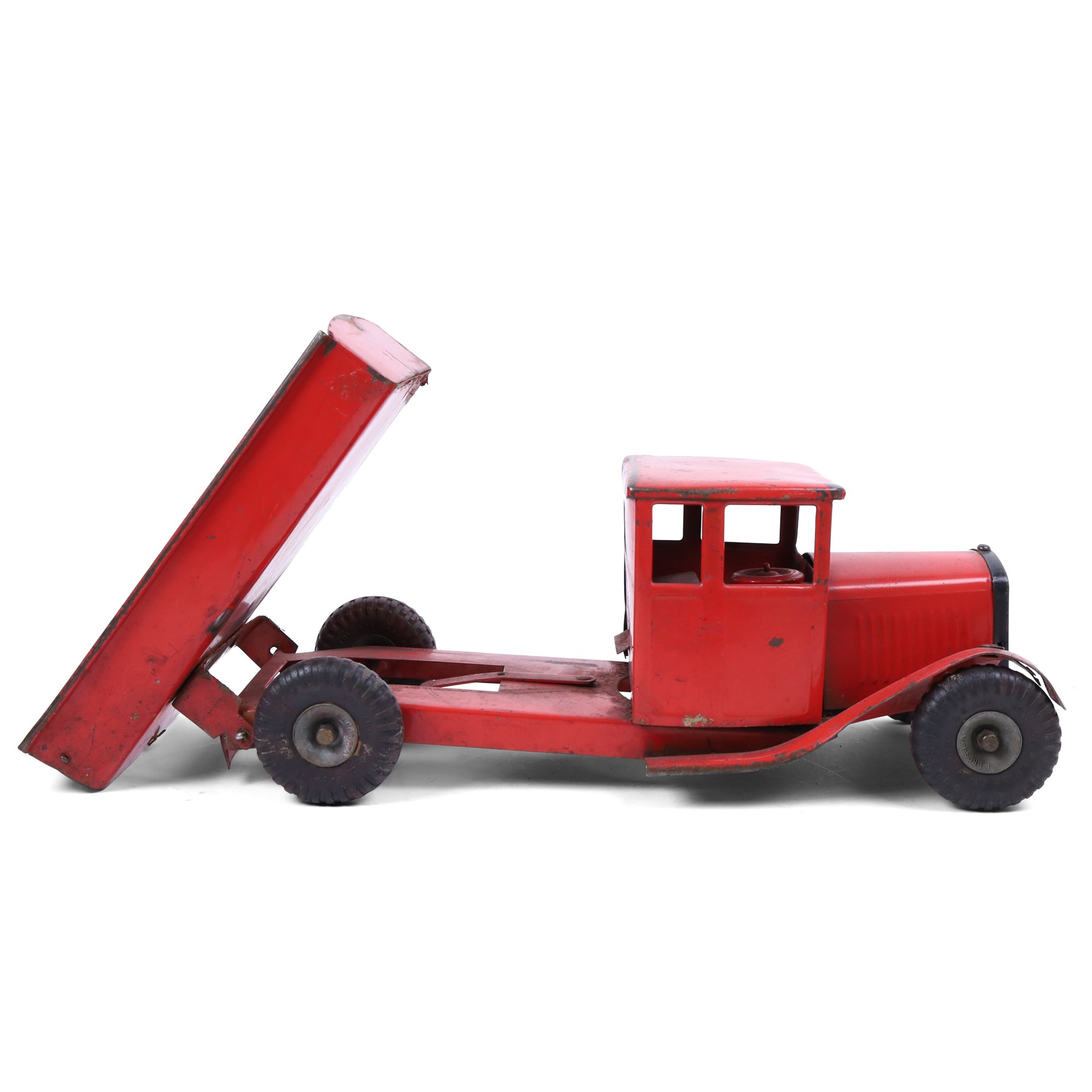 Tri-ang/Line Bros Ltd tin plate tipper truck, red body with black rubber wheels and red seat and steering wheel to interior, H49cm, L16cm