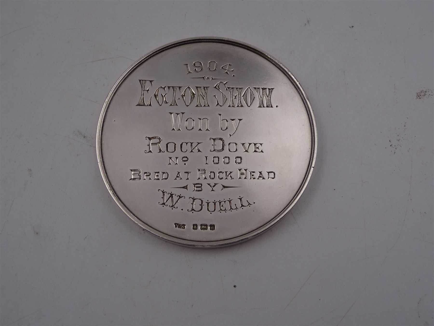 Edwardian silver medal, of circular form, embossed to front with a bay horse and inscribed Cleveland Bay Horse Society, engraved verso 1904 Egton Show won by Rock Dove No 1000 bred at Rock Head by W Duell, hallmarked Vaughton & Sons, Birmingham 1903, contained within fitted case, D6.3cm