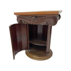 Victorian mahogany vanity unit in the form of a column, the scrolled top with hinged lid revealing mirror, wash bowl and toiletry dishes, on scalloped cylinder pedestal with single door, the interior fitted with shelf