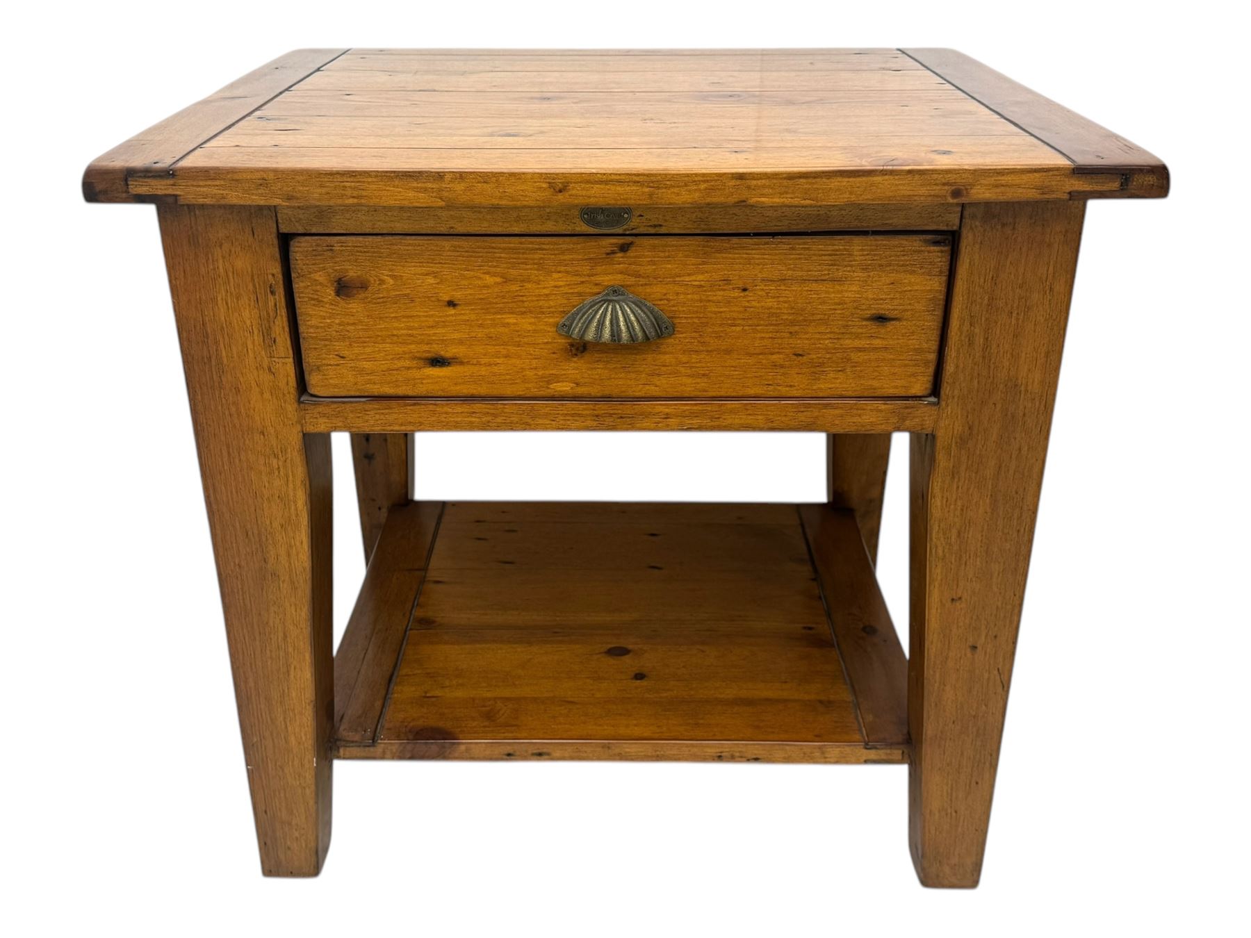 Contemporary hardwood lamp table, the rectangular boarded top over a single drawer with shell cup handle, standing on tapering supports united by undertier 