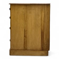 Late 19th-century Victorian stripped pine twin pedestal kneehole dressing table, the rectangular top above three short and three graduated drawers on each pedestal and a central cupboard, on a moulded plinth base 