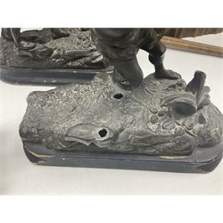 Spanish carved figure of Don Quixote, holding a book, base stamped 'Ouro, together with two spelter figures and one other