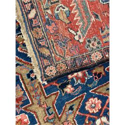 Persian blue ground carpet, the field divided up into panels by trailing bands with flower heads, each panel decorated with palmettes and stylised plant motifs, the border decorated with further palmettes, within floral pattern guard stripes 