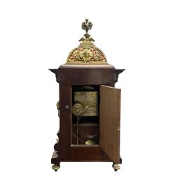 Lenzkirch - Edwardian German 8-day  mantle clock in an oak case with brass mounts and a pierced dome pediment with finial, silvered dial with Arabic numerals, gilt hands and dial centre, rack striking movement, striking the hours and half-hours on a coiled gong. With pendulum and key.