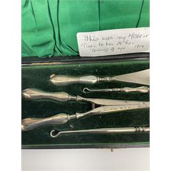 Cased silver handled glove stretcher, button hook, shoe horn, etc., hallmarked Adie & Lovekin Ltd, Chester 1911, and Adie & Lovekin Ltd, Birmingham 1911, miniature silver mounted hymn book, the cover embossed with cherubs, silver handled button hook, ivory handled button hook with silver ferrule, two silver dressing table pot lids, etc. 