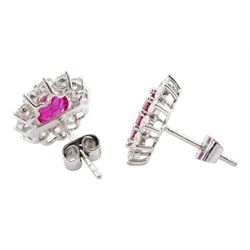 Pair of 18ct white gold oval ruby and round brilliant cut diamond cluster stud earrings, stamped 18K, total ruby weight approx 3.55 carat, total diamond weight approx 2.20 carat
