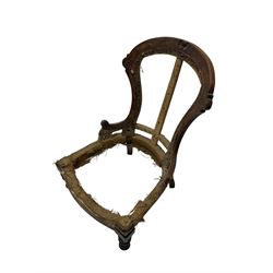 Late Victorian walnut and beech framed nursing chair, with carved scroll decoration, on turned supports 