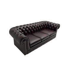 Thomas Lloyd - three seat Chesterfield sofa, upholstered in buttoned oxblood leather, on castors 