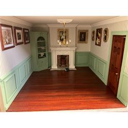 'The Hollies' - good quality sectional wooden doll's house in the form of a Georgian style four-storey bay windowed town house with simulated brick front elevation, rendered sides, off-set corner stonework, faux slate-hung top floor with flat roof and chimney stack, working sash windows, iron railings around front basement courtyard with hinged front elevation to two rooms with  spiral staircase, side hinged central section approached by external steps with iron balustrades to the sides leading to a front door, entrance hall with stairs to landing and two rooms on two floors with dado panelling and fire-surrounds, the top floor with top hung front elevation revealing stairs to a landing and bedroom; wired for electricity L51cm D65cm H107cm including chimney; together with a good quantity of quality wooden furniture and accessories including piano, dressers, bookcase and books, rugs, double half-tester bed, metalware, pictures etc