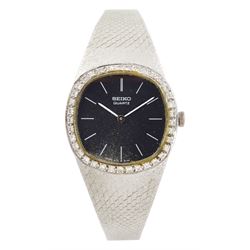 Seiko ladies white gold quartz wristwatch, black dial with baton hour markers and round br...