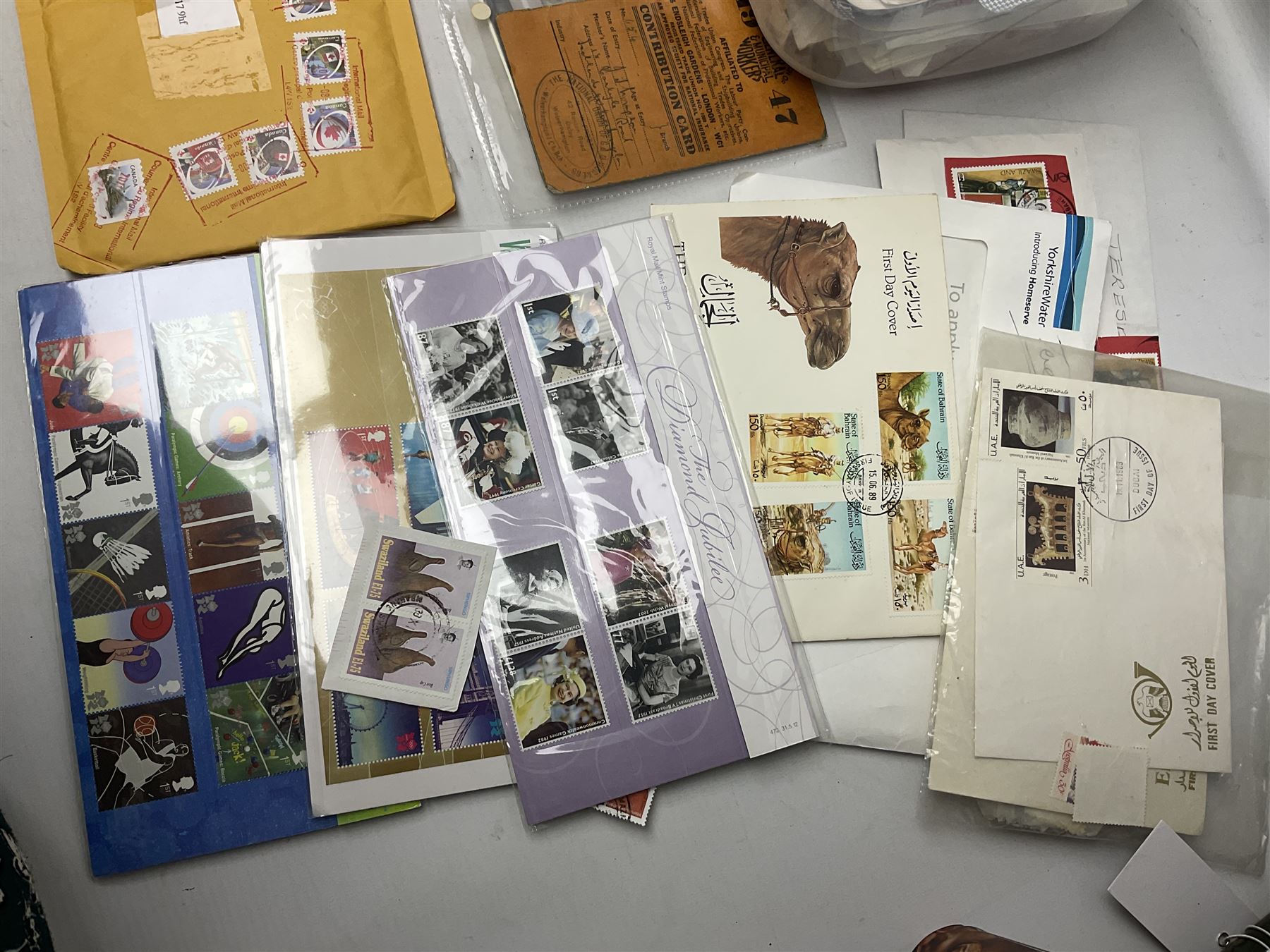 Pair of 9ct gold heart design hoop earrings and 9ct gold pearl earring together with a small collection of silver, costume jewellery and a collection of stamps including some useable postage 