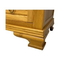 Frank Hudson - contemporary light oak chest, rectangular moulded top over two short and three long drawers, brass oval backplates with circular drop handles, on a moulded plinth base with bracket feet