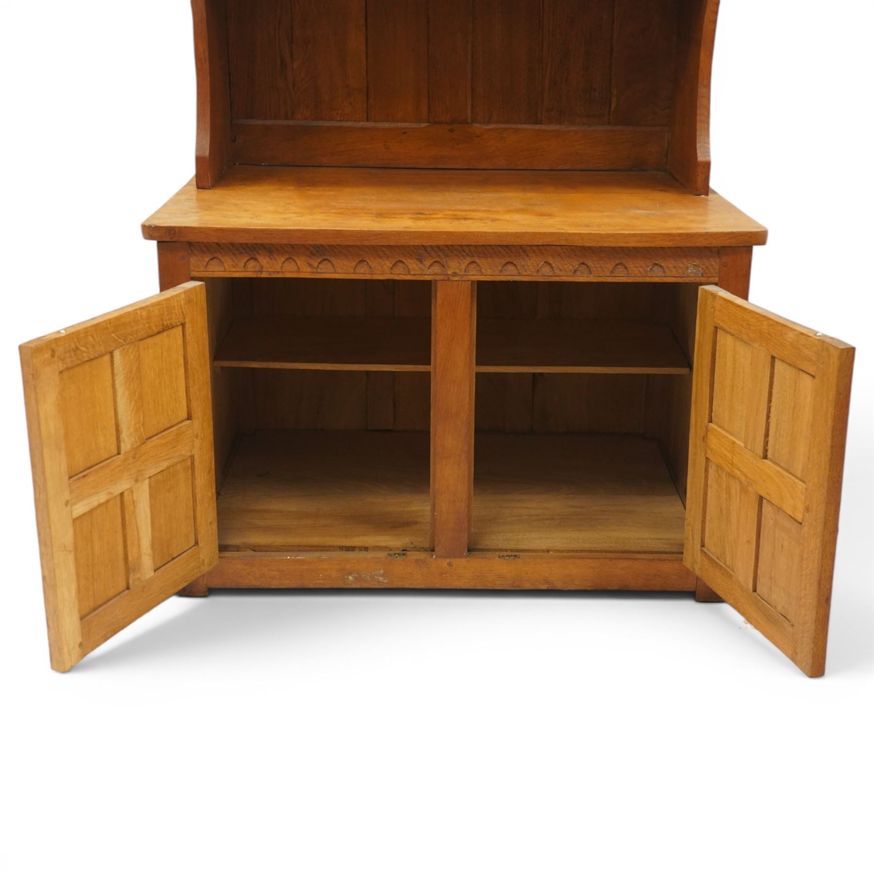 Gnomeman - adzed oak dresser, arcade carved cresting rail over two lead glazed doors, double cupboard below enclosed by two panelled doors, with carved gnome signature, by Thomas Whittaker of Littlebeck 