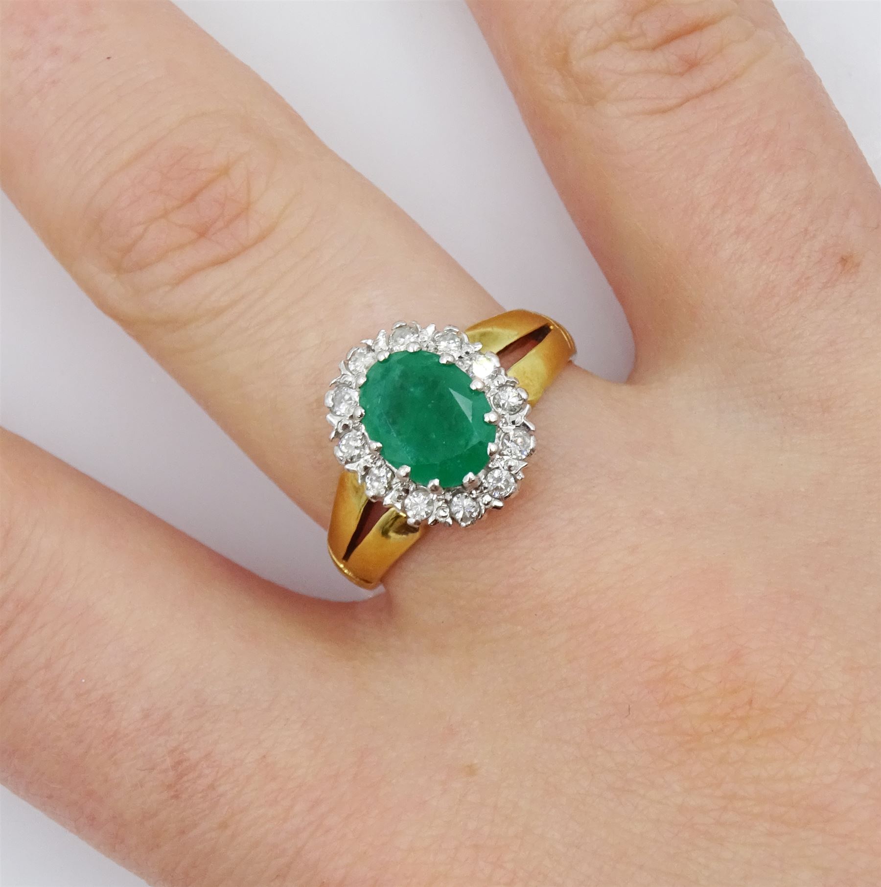 18ct gold oval emerald and round brilliant cut diamond cluster ring, London 1979