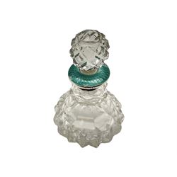 Cut glass perfume bottle of bellied form, the silver mounted cover with turquoise guilloche enamel top, hallmarked Henry Perkins & Sons, London 1927, together with a cut glass perfume bottle with silver mounted and yellow guilloche enamel lid, hallmarked Albert Carter, Birmingham 1950, Continental silver perfume bottle, of barrel form with embossed figural detail, stamped 930, scent bottle of bellied form with white metal foliate pierced overlay, amethyst glass scent bottle of flask form with foliate embossed white metal cover and suspension ring and chain, and three further examples, including one of ovoid form with painted decoration and silver cover, hallmarked for Birmingham.