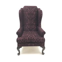 Traditional Queen Anne style high wingback armchair upholstered in purple fabric with raised scrolling pattern, on cabriole feet