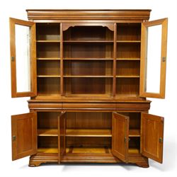 Barker & Stonehouse - large cherrywood bookcase cabinet, the moulded cornice above two glazed doors flanking an open central section, the base with three cushion drawers over four lockable panelled cupboard doors, raised on bracket feet
