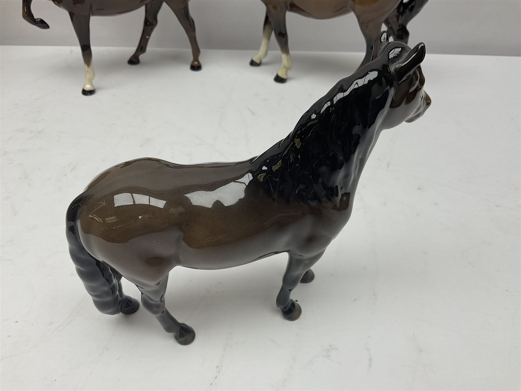 Four Beswick horses, including Exmoor no 1645, Black Beauty foal and two others 
