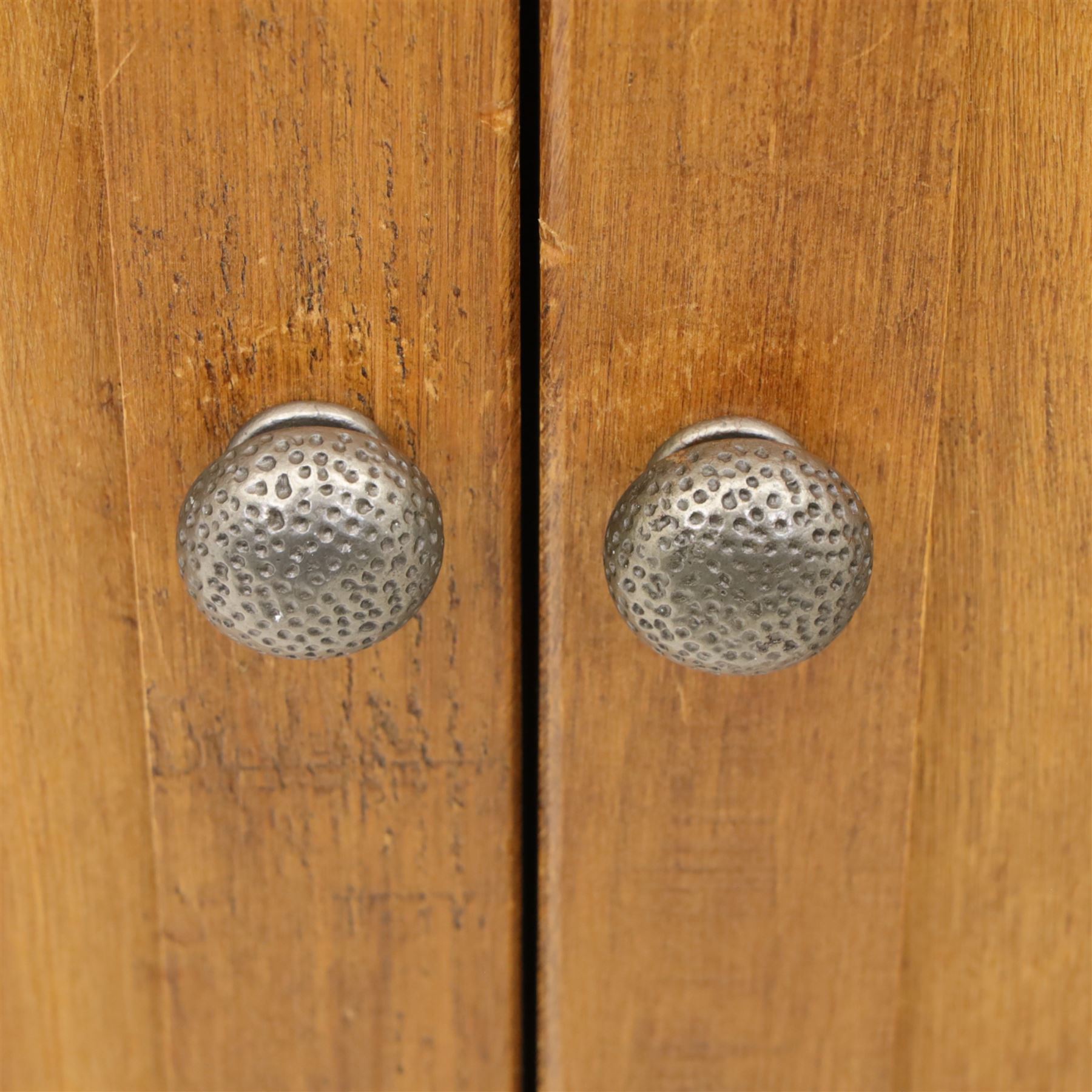 Contemporary pine hanging wardrobe, twin panelled doors enclosing open hanging space with brass rail, two drawers to lower section, on moulded plinth base
