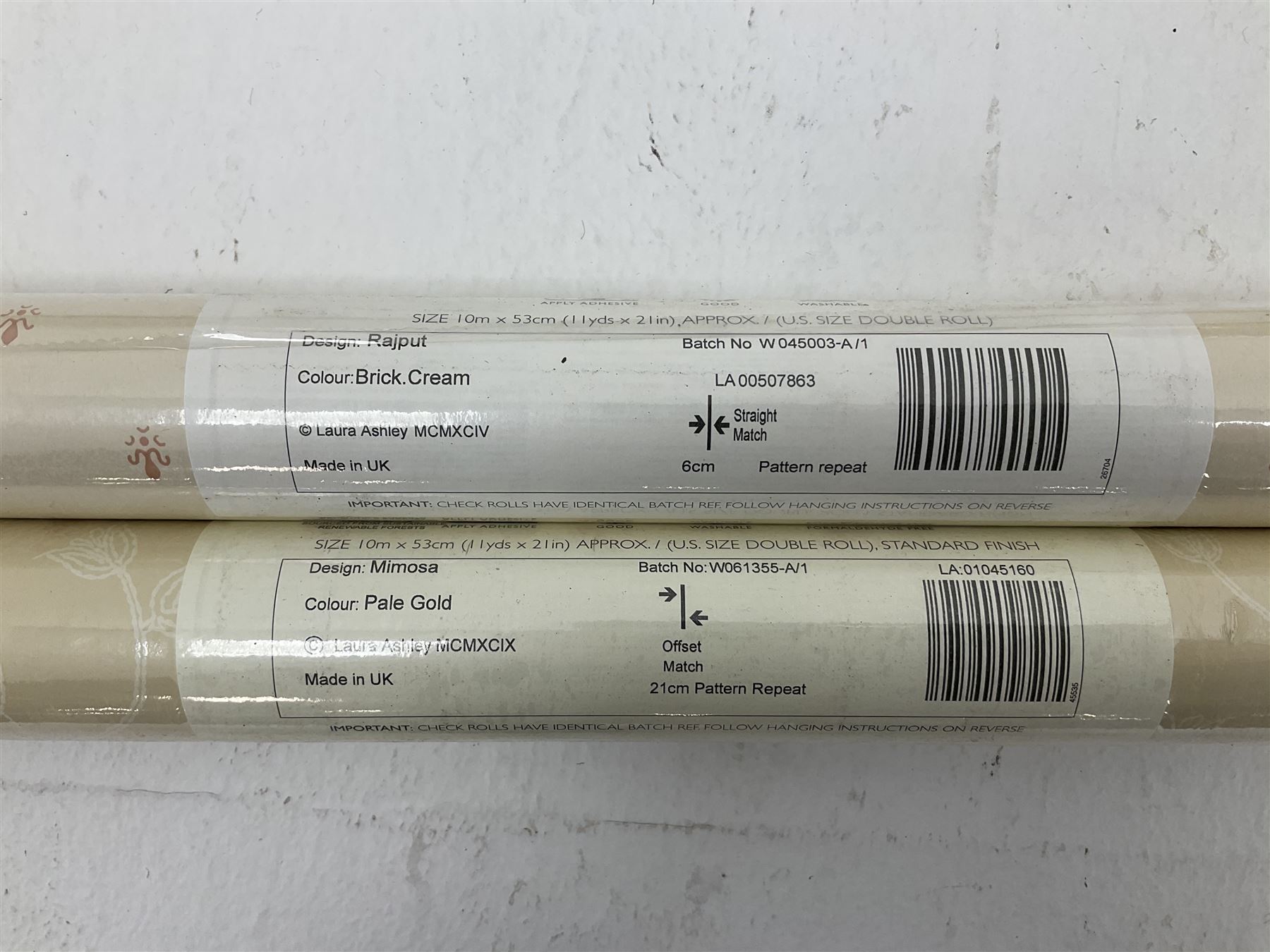 Five rolls of Laura Ashley Brick Cream wallpaper (L10m, W53cm), two rolls of Laura Ashley pale gold wallpaper (L10m, W53cm), seven rolls of Laura Ashley Delaney Gold wallpaper (W10m, W53cm)
