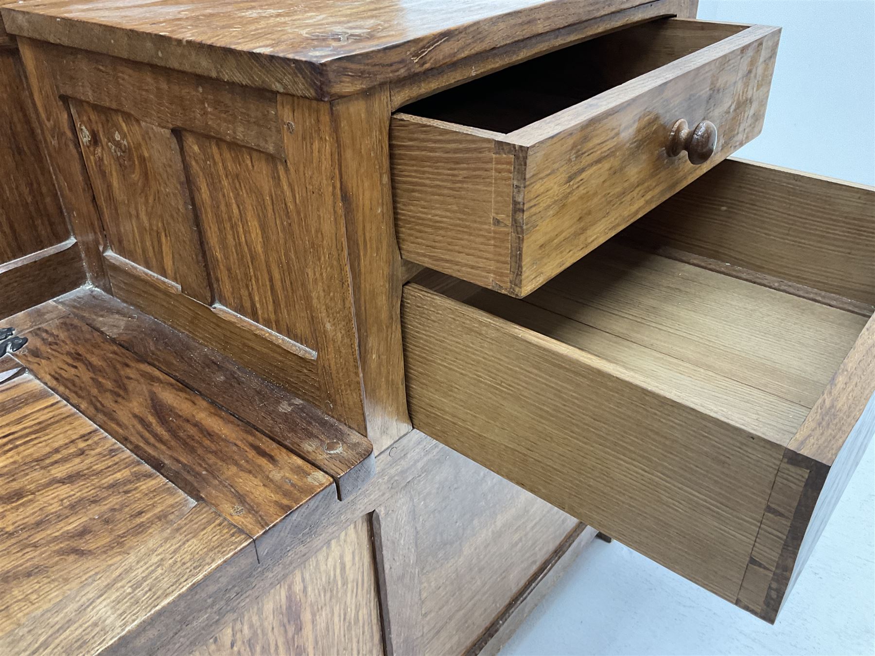 'Acornman' figured oak telephone table, panelled back above hinged seat and two drawers, panelled sides and front, all over adzing, by Alan Grainger of Brandsby, York