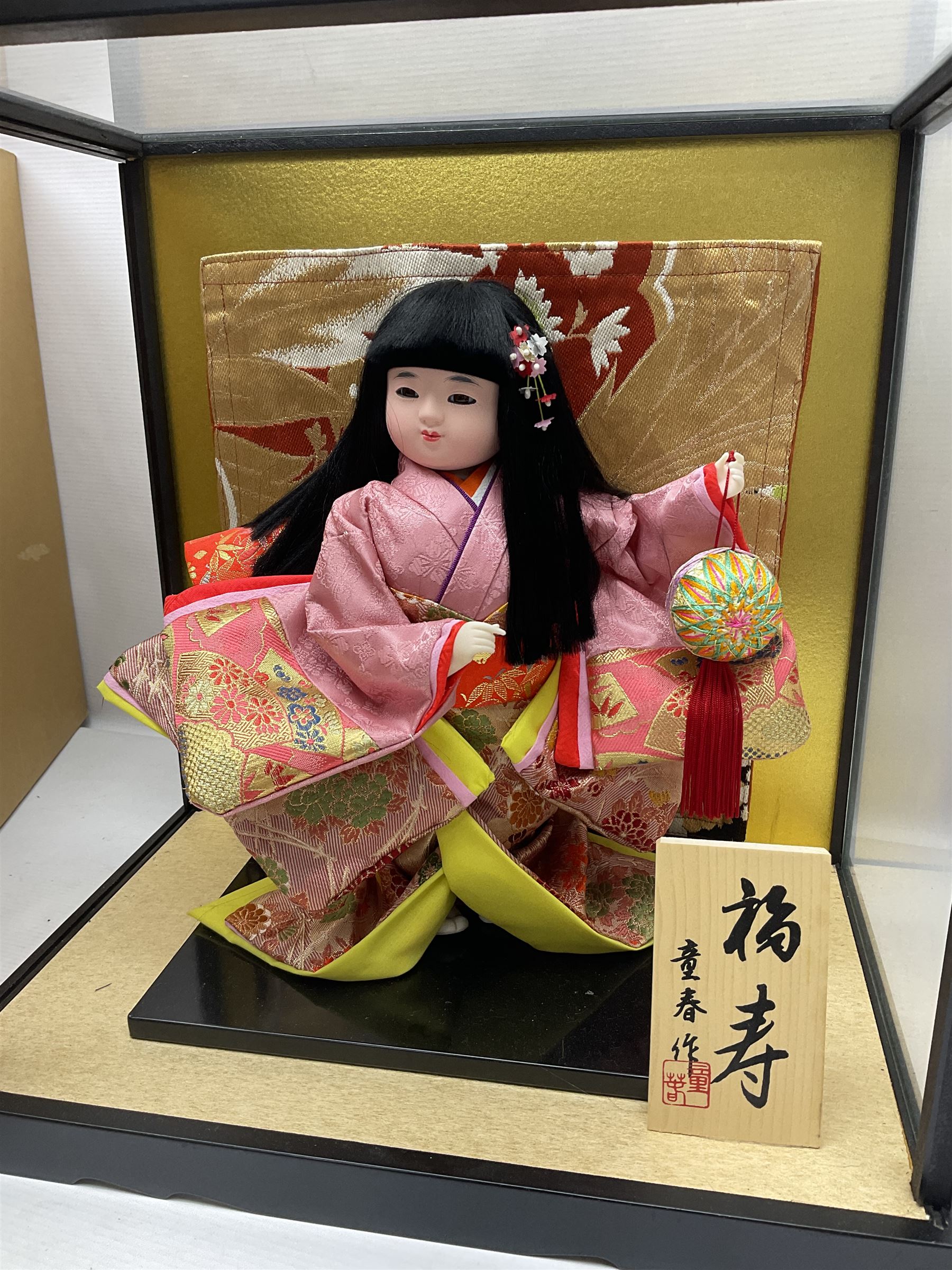 Japanese doll, dressed in traditional Japanese dress, within wooden glazed box, box H40cm