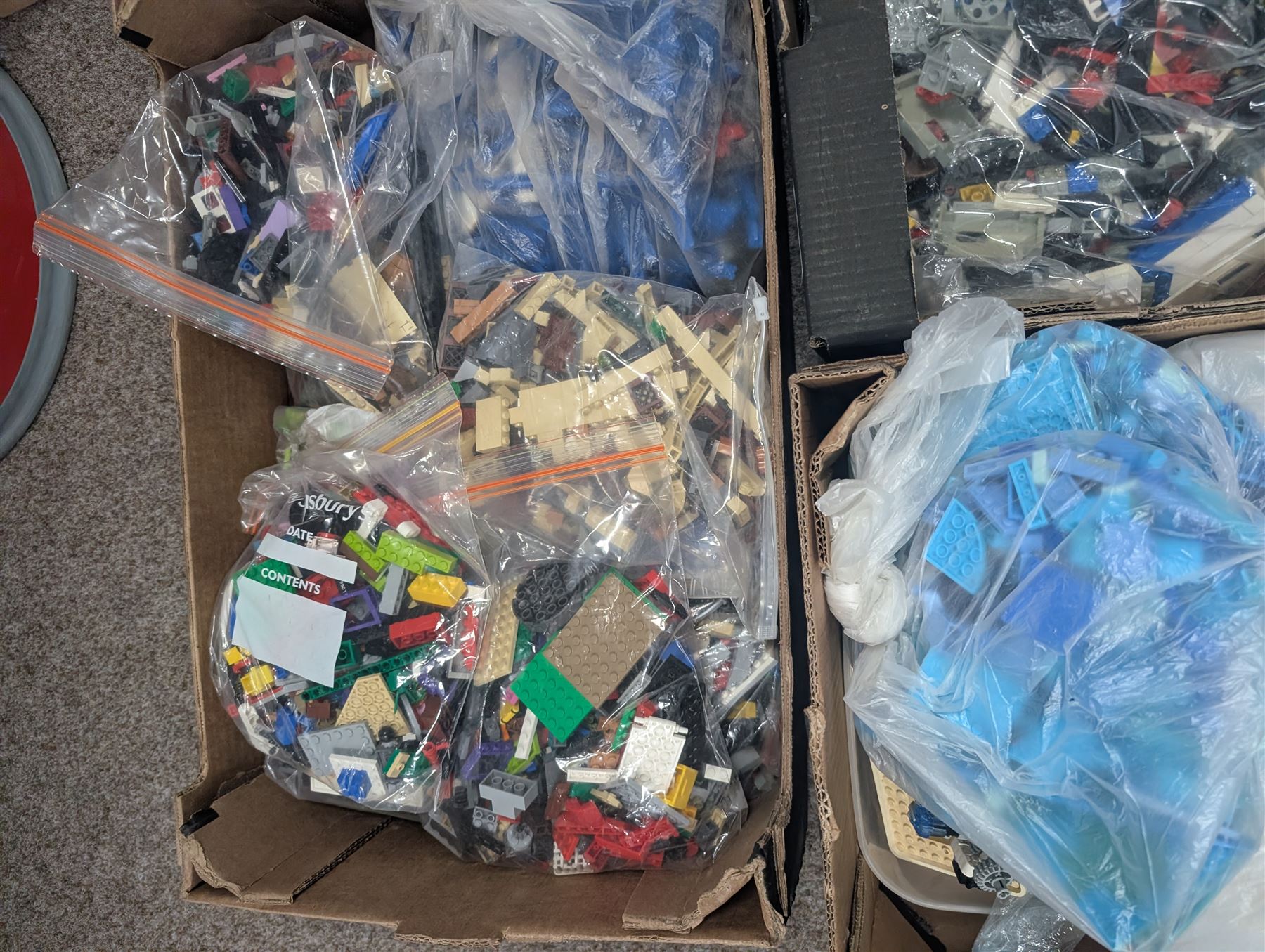 Large collection of loose Lego, including minifigures, together with three Lego ideas books, in five boxes