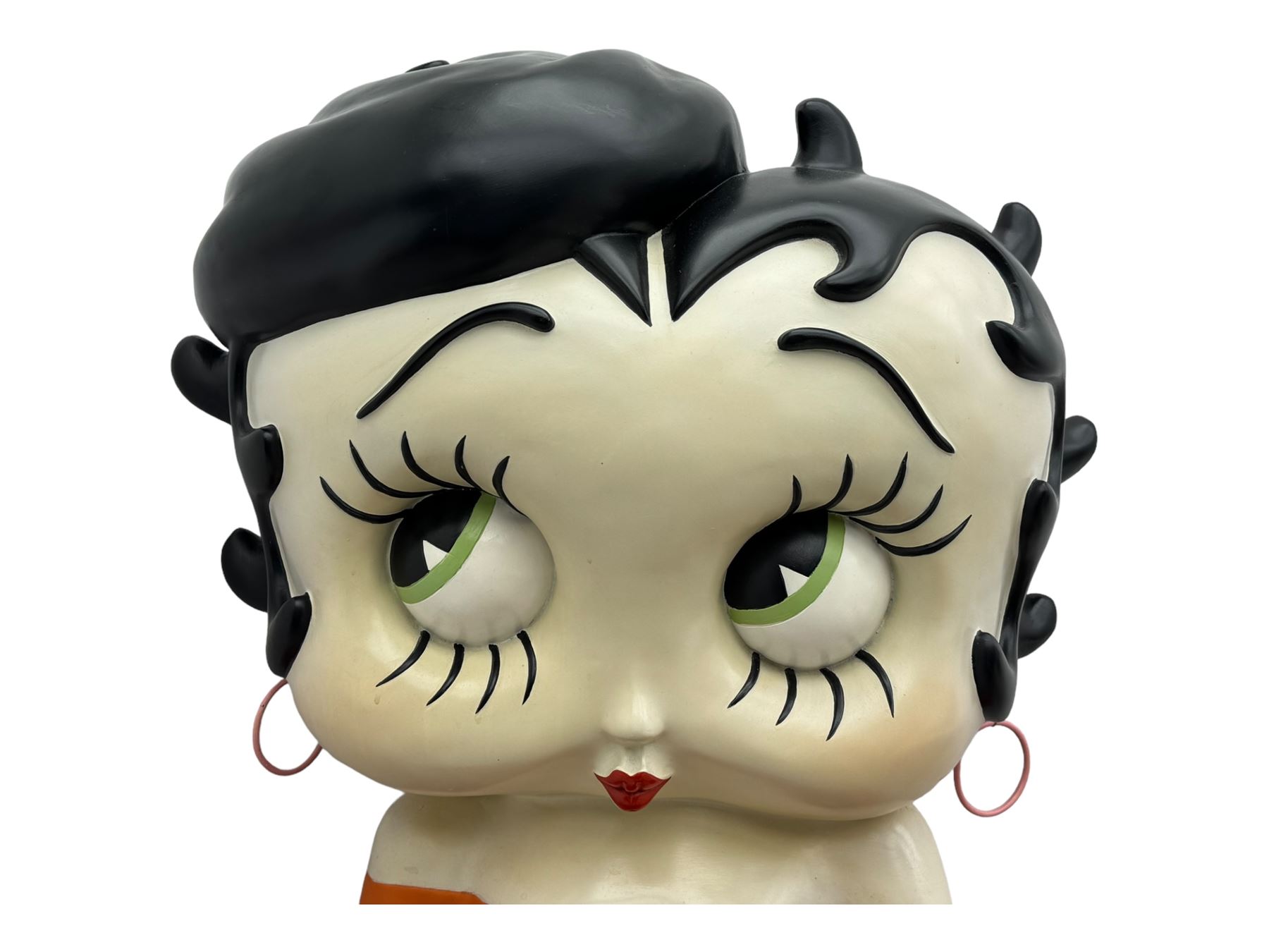 Contemporary large-scale Betty Boop painted wine rack, modelled leaning against a heart-shaped stand with ten circular bottle slots, dressed in black and orange striped attire
