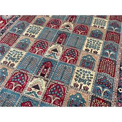 Persian Bakhtiari crimson ground carpet, the field divided into seventy panels decorated tree of life motifs, mihrabs and stylised plants, the border decorated with repeating circular medallions formed of Hac motifs, floral pattern guard stripes 