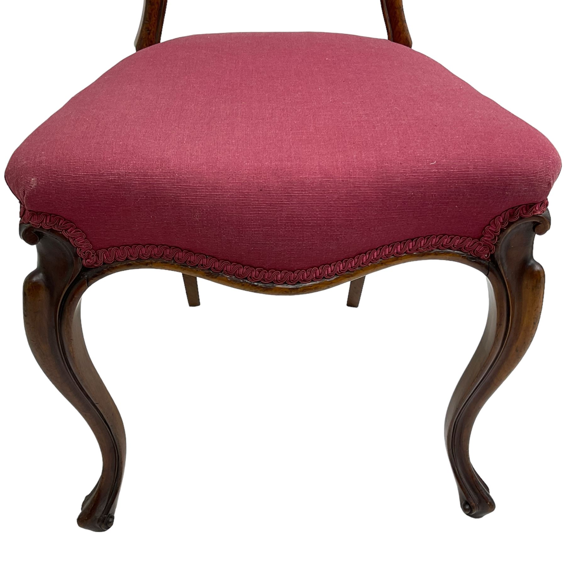 Set of six Victorian rosewood dining chairs, the balloon back carved with foliage scrolls, cartouche carved middle rail with extending scrolls, the seats upholstered in pink fabric, on carved cabriole supports with scrolled terminals 