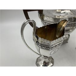 Victorian silver four piece tea service, comprising teapot, teapot stand, twin handled open sucrier and milk jug, each of octagonal form with foliate bud border and engraved decoration including crest to canted panels, and vacant panels, the teapot with ivory finial to the hinged cover and later wooden handle, hallmarked Edward Barnard & Sons Ltd, London1896, teapot including finial H15cm, milk jug including handle H16cm, teapot stand W11.5cm

This item has been registered for sale under Section 10 of the APHA Ivory Act