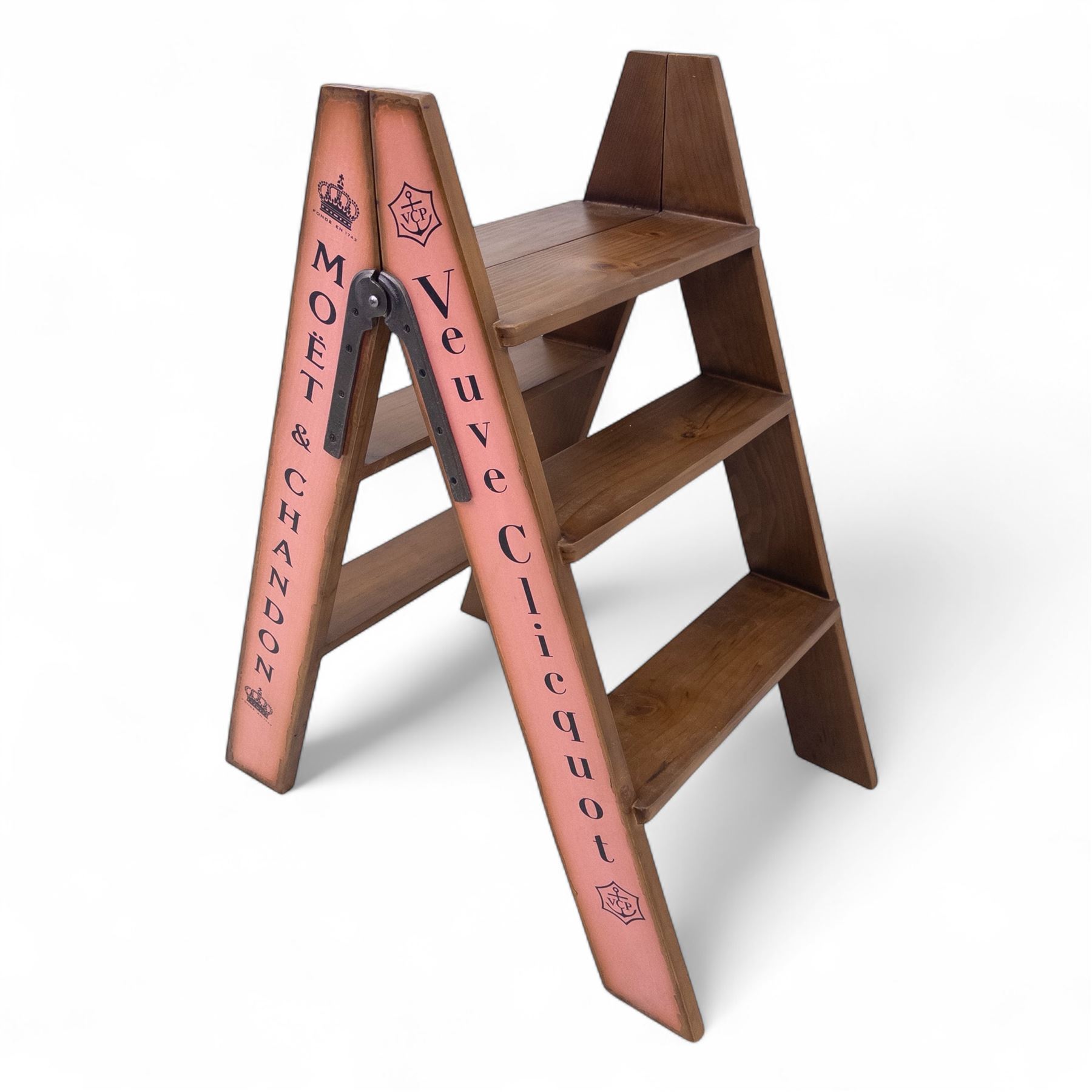Three-piece champagne advertising display set, comprising pine steps with painted Dom Pérignon and Bollinger lettering, and two wooden boxes branded Moët & Chandon and Veuve Clicquot (Steps H 80cm, W 44cm, D 68cm, crates each H 18cm, W 44cm, D 26cm)