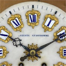 Auguste GP. Andhomme - French vineyard clock,  late 19th century 8-day twin train spring driven wall clock with enamelled and inlaid brass decoration within an ebonised and glazed case, circular enamel dial with cartouche Roman numerals, minute markers, pieced steel hands and a chased brass slip, striking movement, sounding the hours and half hours on a coiled gong. With pendulum and key.  
