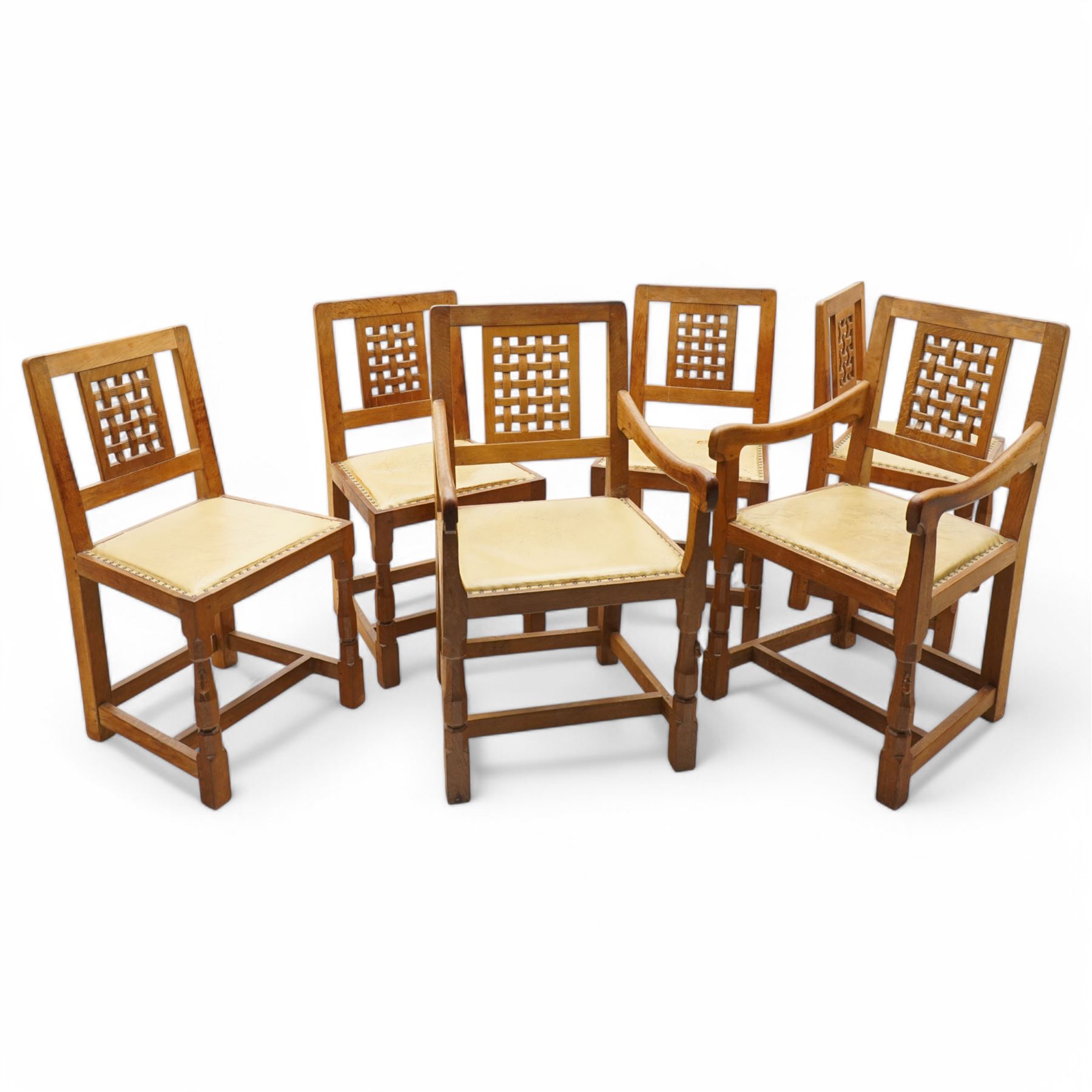 Mouseman - set of six (4+2) oak dining chairs, pierced and carved lattice back over leather upholstered seat, on octagonal front supports united by stretchers, carved with mouse signature, by the workshop of Robert Thompson, Kilburn