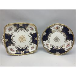 Coalport cobalt blue batwing pattern tea wares, decorated with finely enamelled floral sprays within gilt reserves, comprising teacup trio, coffee can and saucer and other cup and saucer, twin handled cake plate, milk jug and open sucrier, and circular plate retailed by T. Goode & Co London, pattern no Y2665,  all with green Coalport AD 1750 marks beneath, largest W26cm (11)