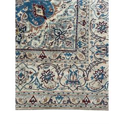 Persian Nain blue and ivory ground rug, wool with silk inlay, overall arabesque design, central medallion surrounded by interlacing and scrolled leafy branches and palmettes, the scrolling border decorated with stylised plant motifs, within guard stripes