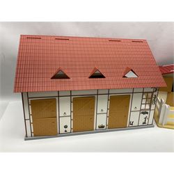 Sectional wooden horse stables playset by Julip with two stalls and tack room under a pitched roof, base 59 x 47cm; and another sectional plastic stables playset by Schleich with three stalls under an open pitched roof, base 56 x 36cm (2)