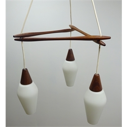  1970s Scandinavian teak three light centre light fitting, with white frosted tapered glass shades, in the style of designer & Uno Kristiansson, H89cm   