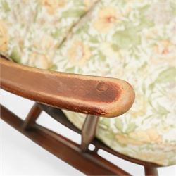 Ercol - Mid-20th century ‘Fleur-de-Lis’ rocking chair, elm and beech frame with curved arms, pierced back crest and stick supports, floral upholstered seat and back cushions, on curved rockers