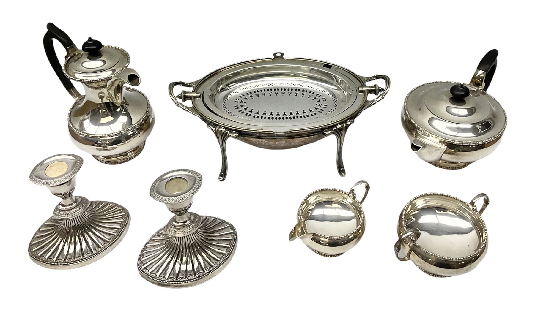 Collection of silver plate to include pair of Falstaff dwarf candlesticks in the 'Adam' style, weighted and raised upon fluted oval bases, together with Walker & Hall coffee pot, teapot, twin handled sucrier and jug in pattern no. 53602, and a Finnigans of Manchester entrée dish, the revolving top with engraved monogram